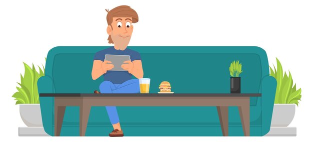 Homme assis sur un canapé à table basse avec tablette
