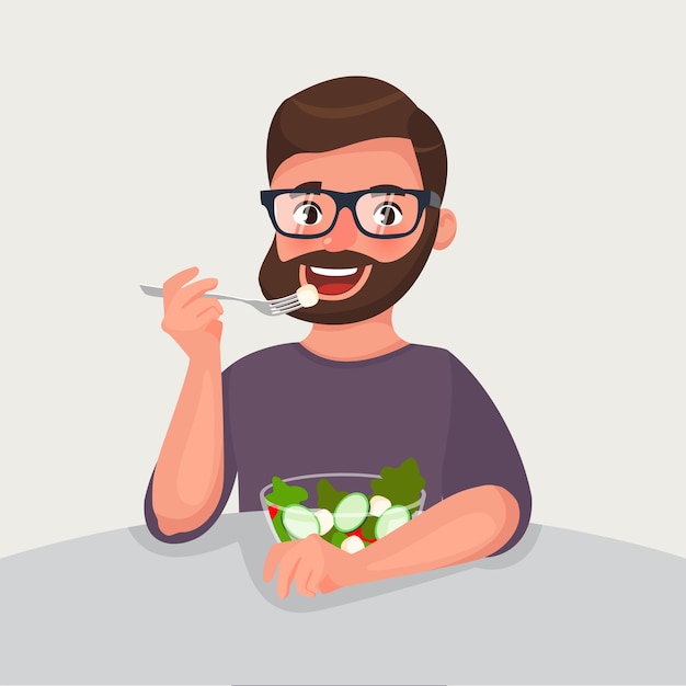 Homme barbe hipster mange une salade