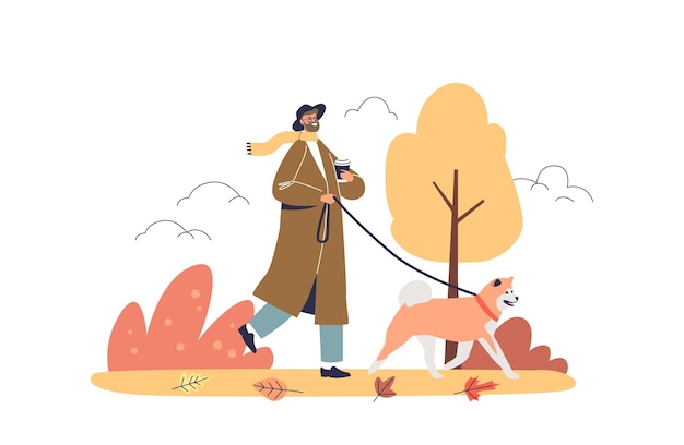 Homme marchant chien dans le parc d'automne