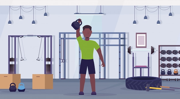 Homme De Sport Faire Des Exercices Avec Kettlebell Guy Afro-américain Formation En Salle De Gym Concept De Mode De Vie Sain Club De Santé Moderne Intérieur Studio Horizontal