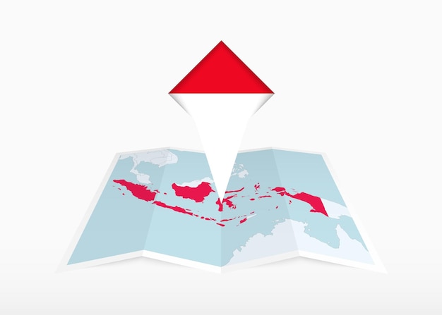 L'Indonésie est représentée sur une carte en papier pliée et un marqueur d'emplacement épinglé avec le drapeau de l'Indonésies.