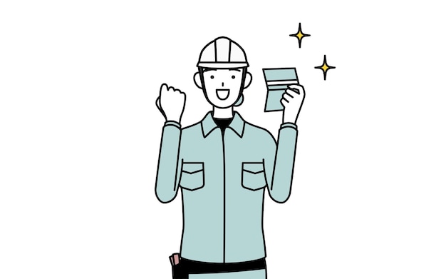 Ingénieure en casque et en tenue de travail qui est heureuse de voir un livre de banque