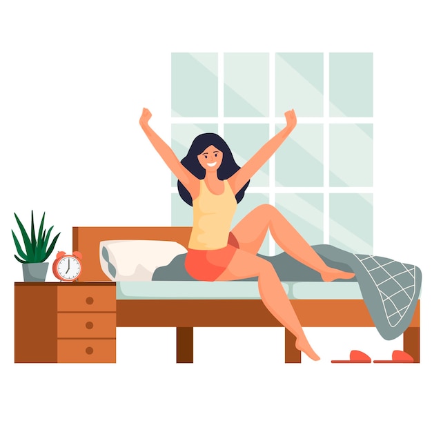 Jeune femme en bonne santé se réveillant le matin en souriant et en étirant ses bras alors qu'elle s'assoit dans son lit