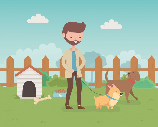 Jeune homme avec des mascottes de petits chiens mignons dans le champ