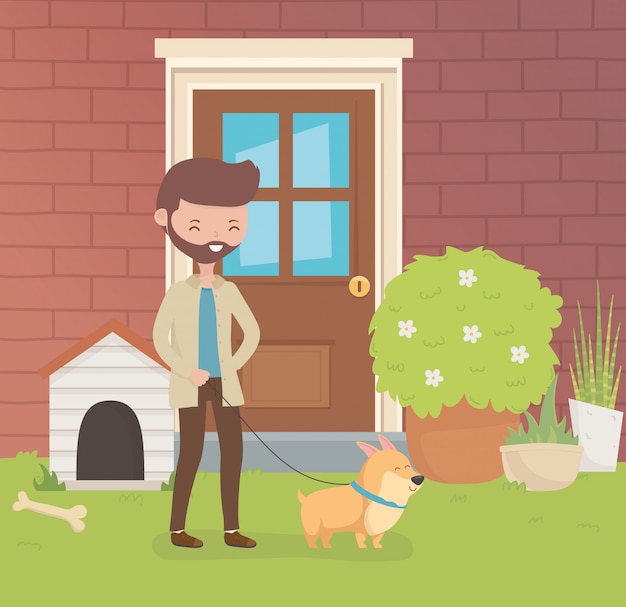 Jeune homme avec une petite mascotte de chien dans le jardin de la maison