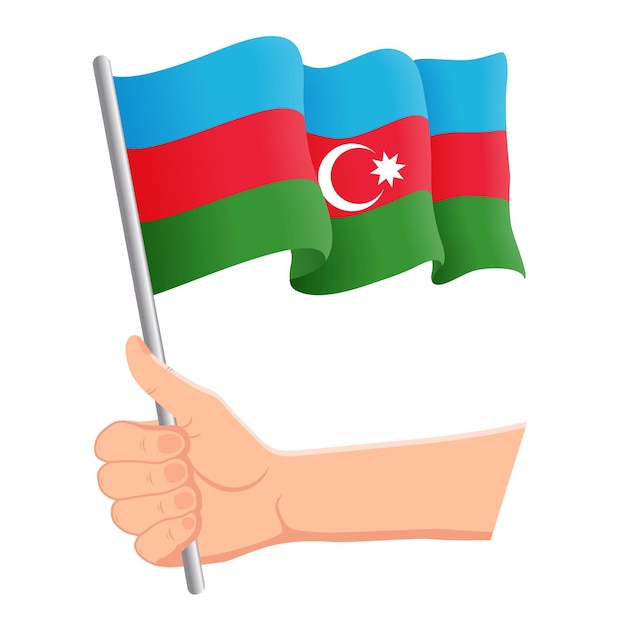 Main tenant et agitant le drapeau national de l'Azerbaïdjan Concept patriotique de la fête de l'indépendance des fans