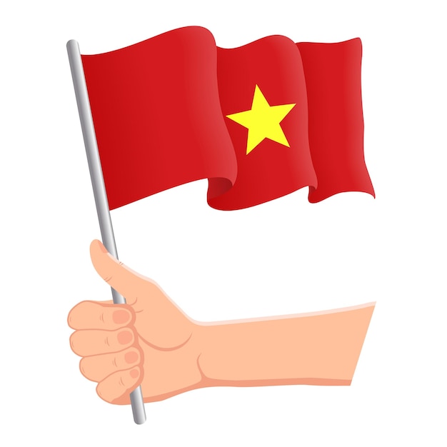 Vecteur main tenant et agitant le drapeau national du vietnam fans concept patriotique de la fête de l'indépendance illustration vectorielle