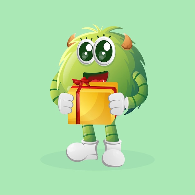 Monstre vert mignon tenant une boîte-cadeau