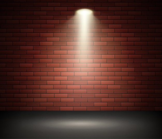 Scène éclairée par un projecteur contre le mur de briques