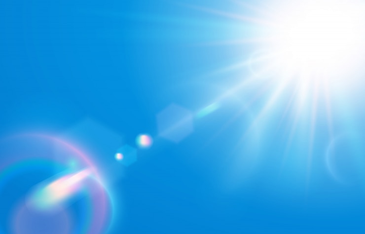 Vecteur soleil dans le ciel bleu. éblouissement de la lentille solaire chaude dans un ciel clair, une journée ensoleillée et des rayons de soleil