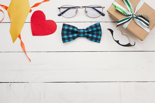 Vecteur une table blanche a une paire de lunettes un cœur et une paire de verres sur elle