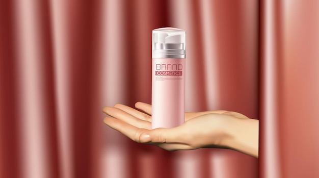 Womens mains sur un tissu rose backgrounda femme produit cosmétique sur ses mains