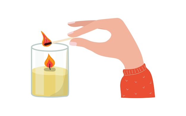 Female hand with burning match candle in glass jar Burning wax cozy candle flame Man lights a fire
