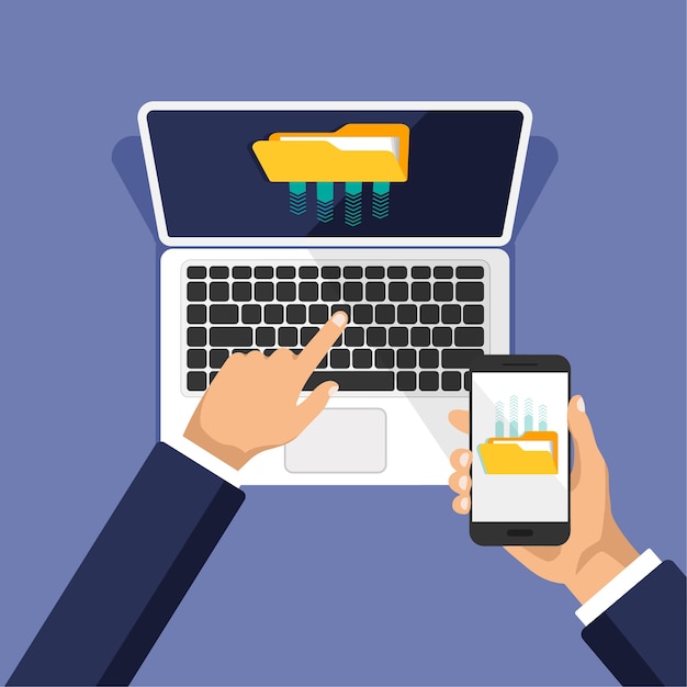Hand holds phone, clicks on laptop keyboard.Businessman uploads files to cloud storage or computer.