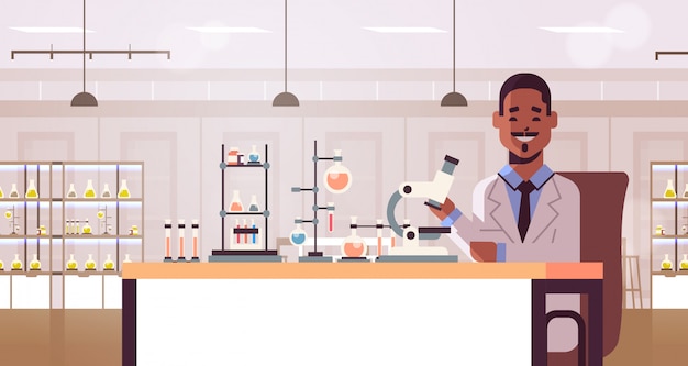 scientist using microscope and test tubes