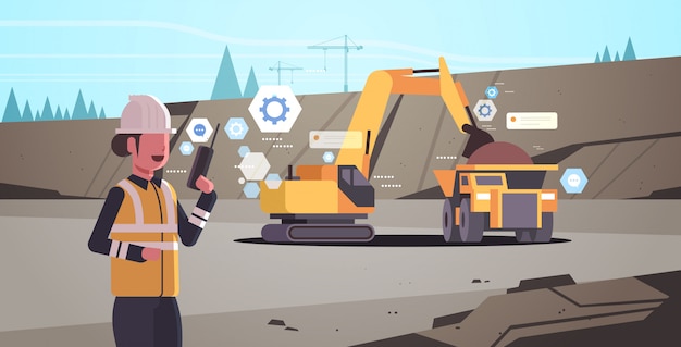 woman in helmet using walkie talkie controlling excavator