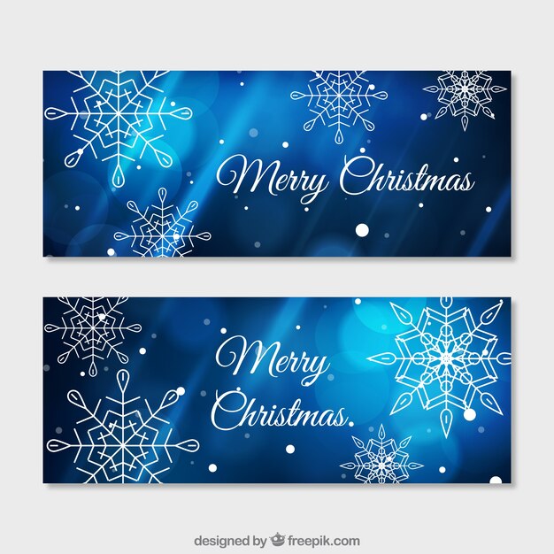Banners de copos de nieve en un fondo bokeh azul