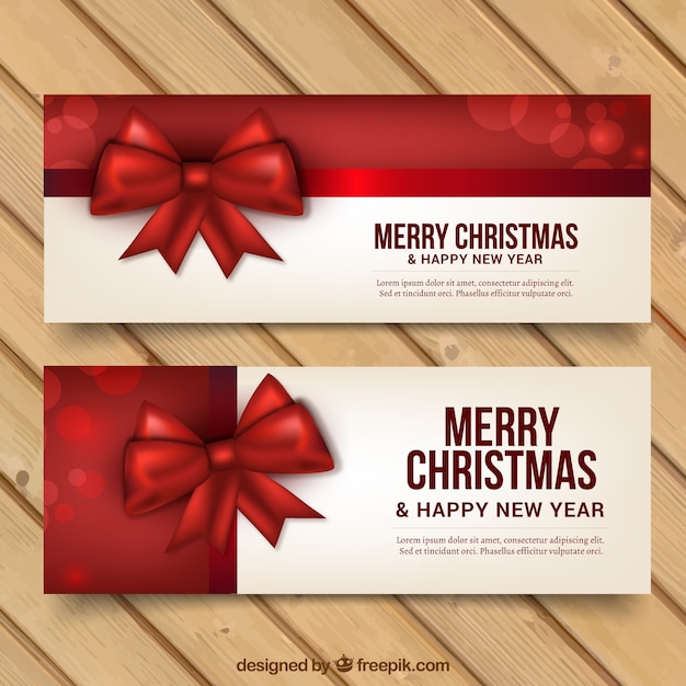 Banners de feliz navidad y año nuevo con lazos rojos 