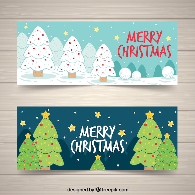 Banners de feliz navidad con árboles dibujados a mano