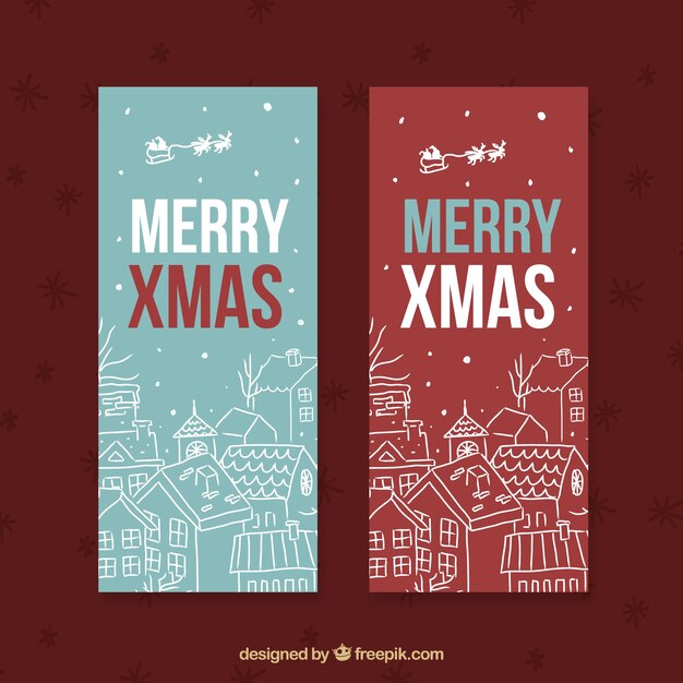 Banners de feliz navidad con bocetos de casas