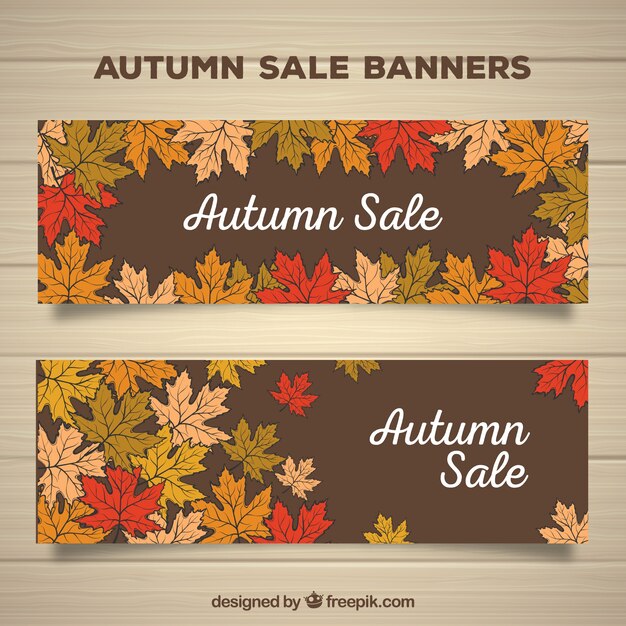 Banners a mano de rebajas de otoño con hojas
