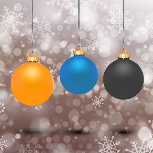 Bolas de navidad naranja, azul y negra sobre fondo bokeh