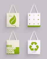 Vector gratuito bolsa de tela tote maqueta conjunto realista de cuatro imágenes aisladas con bolsas de tela e ilustración de vector de arte ecológico
