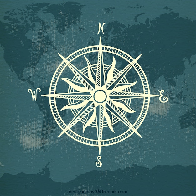 Brújula sobre fondo de mapa del mundo