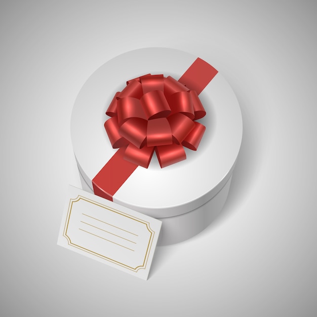 Caja de regalo clásica con cinta roja, arco y etiqueta en blanco