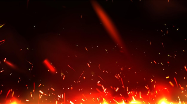 Las chispas de fuego brillantes se elevan sobre un fondo oscuro.