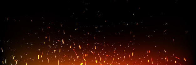 Las chispas de fuego flotando hacia arriba en el fondo oscuro