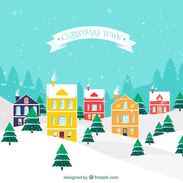 Ciudad nevada con casas navideñas de colores