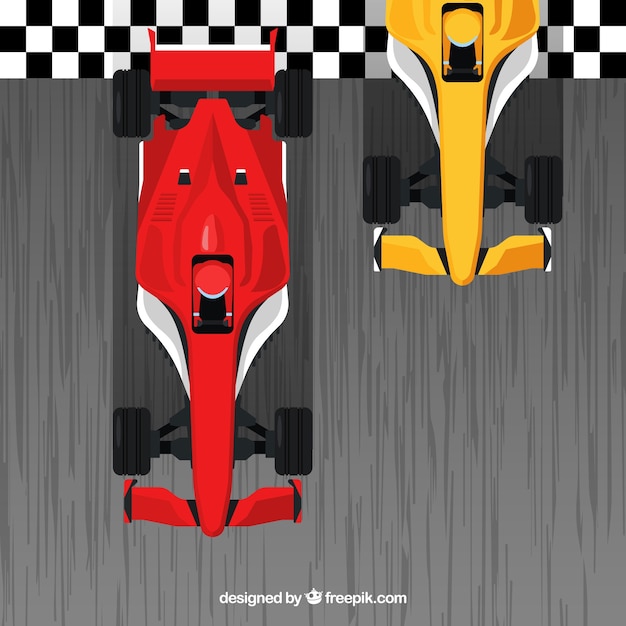 Coches de formula 1 rojos y naranjas pasando línea de meta