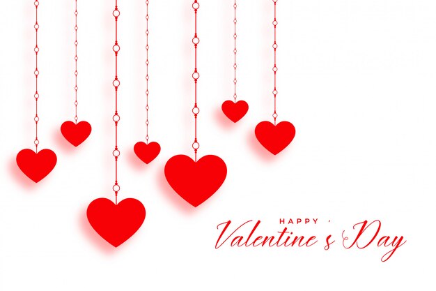 Colgando corazones rojos en el día de San Valentín blanco