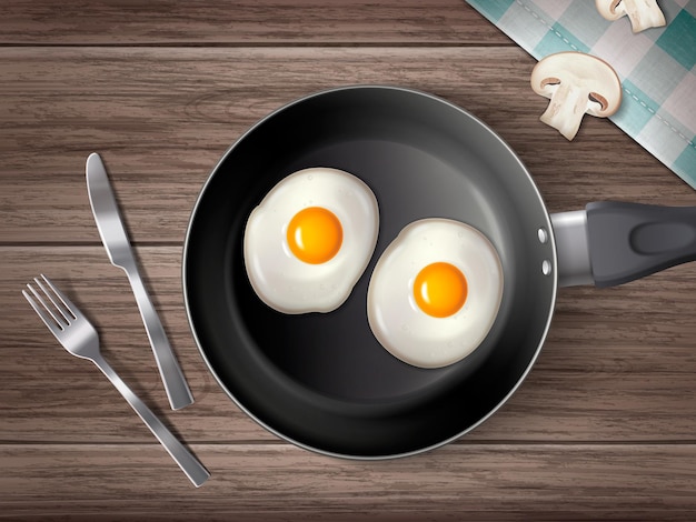 Vector gratuito composición realista de utensilios de cocina con vista superior de cubiertos y sartén con dos huevos fritos en la ilustración de vector de fondo de superficie de madera