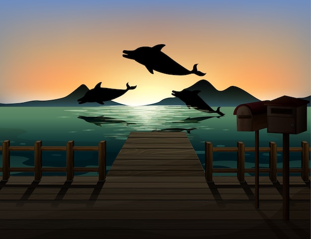 Vector gratuito delfín en silueta de escena de la naturaleza