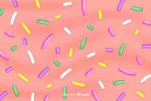Vector gratuito delicioso snack de confeti de azúcar sobre fondo rosa