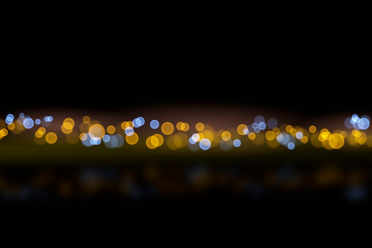 Vector gratuito efecto de luces bokeh sobre estilo de fondo oscuro