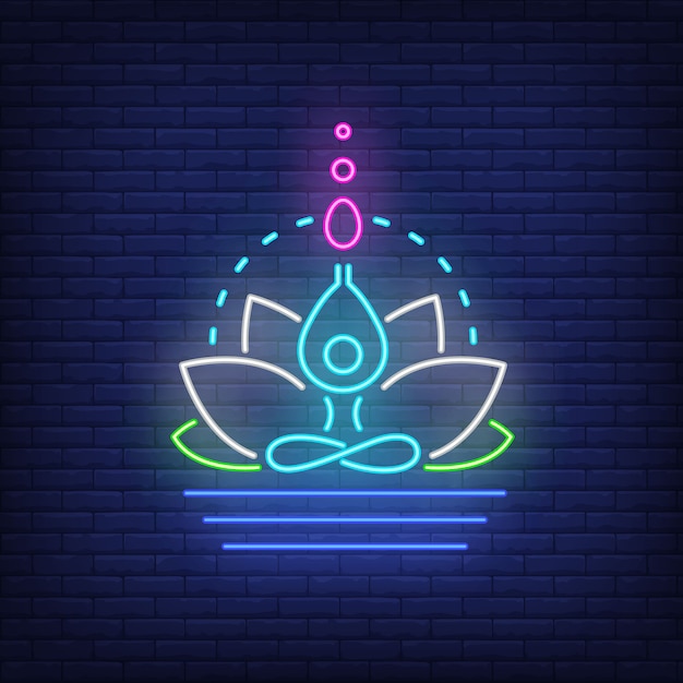 Flor de loto y figura de neón meditando. meditación, espiritualidad, yoga.