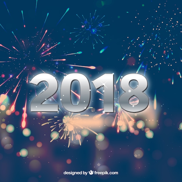 Fondo de año nuevo 2018 borroso con fuegos artificiales
