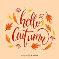 Vector gratuito fondo caligráfico de hola otoño con hojas