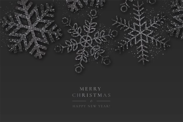 Fondo negro de Navidad con copos de nieve brillantes