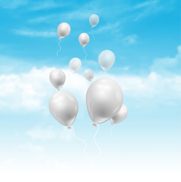 Globos flotando en un cielo azul con nubes blancas esponjosas