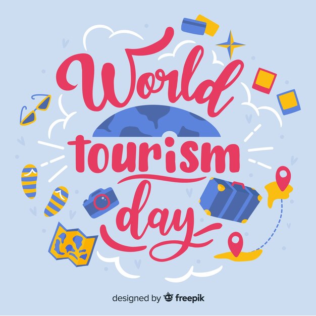 Letras del día mundial del turismo con objetos de viaje