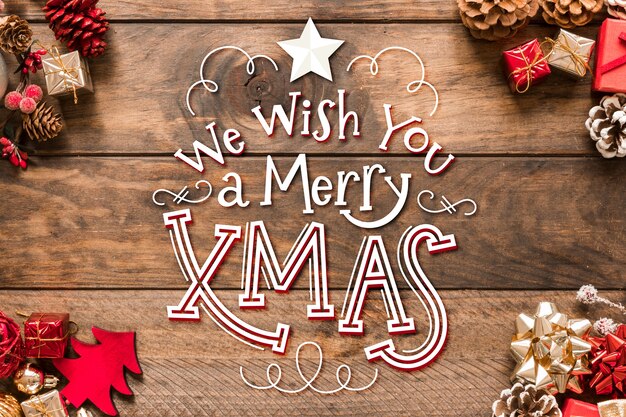 Letras de feliz navidad con piñas y regalos