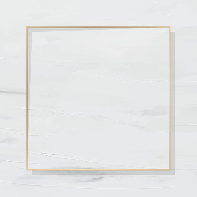 Marco cuadrado dorado sobre fondo pintado de blanco