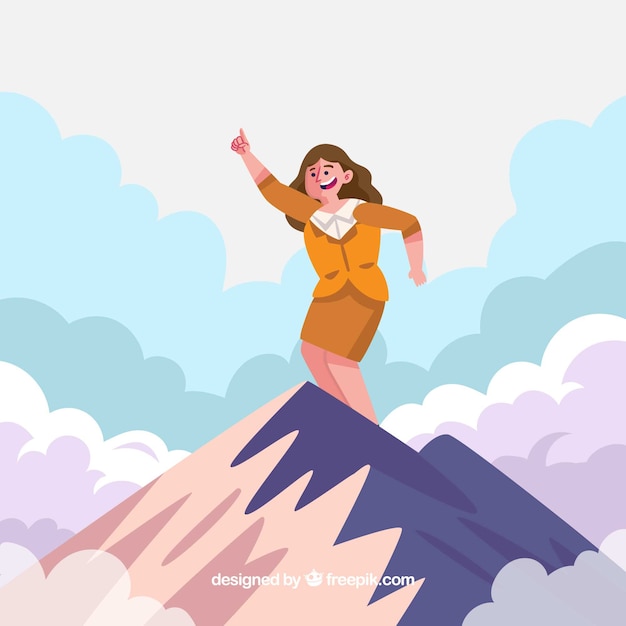 Mujer de negocios feliz en la cima de una montaña