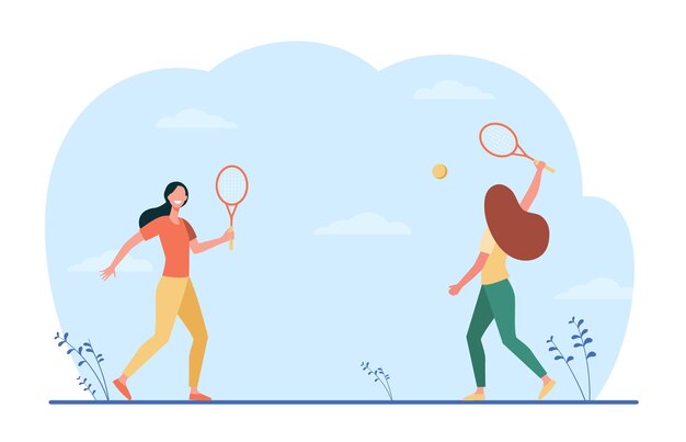 Mujeres felices jugando en bádminton al aire libre