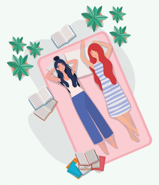 Mujeres jóvenes relajándose en un colchón en el dormitorio