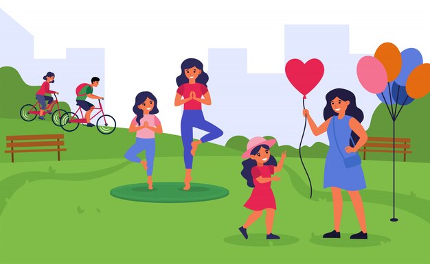 Mujeres que pasan tiempo con hijas pequeñas en parque público